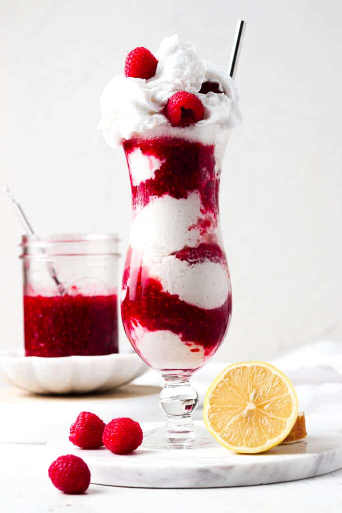 Champagne float in a cocktail glass with whipped cream