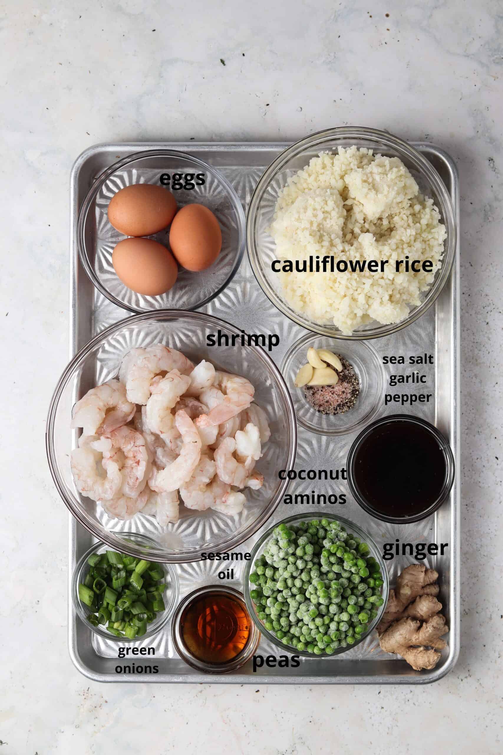 Shrimp fried cauliflower rice ingredients on a metal tray.