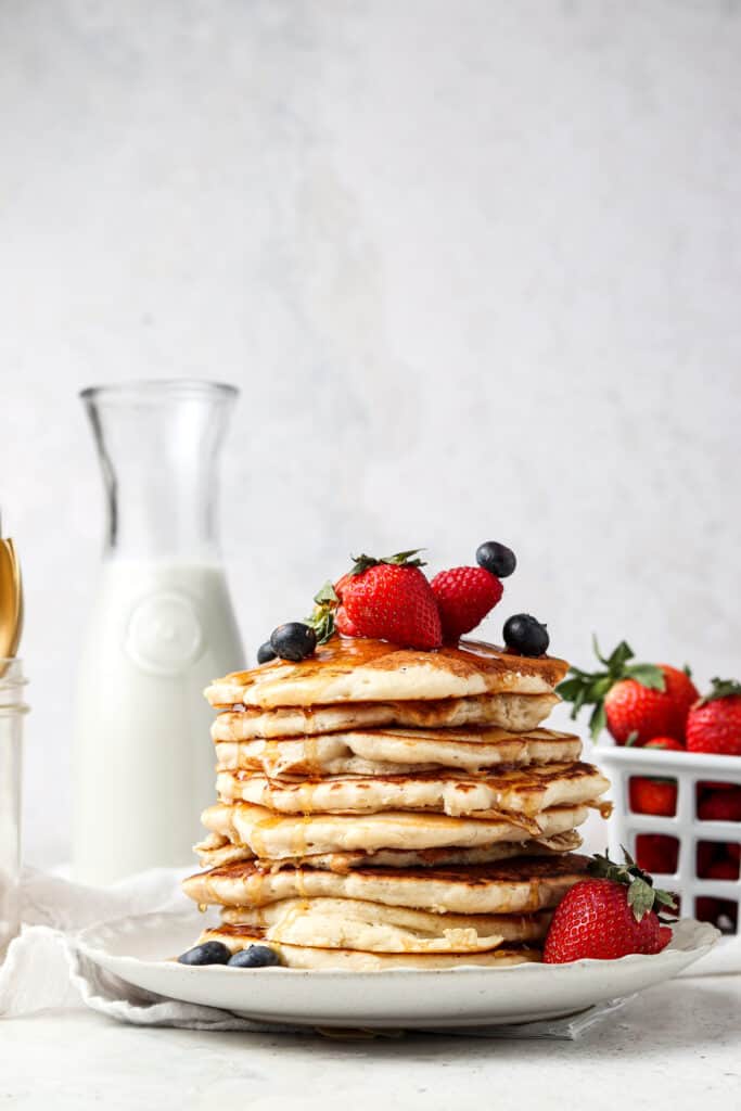 aip pancakes on a plate with fresh berries and syrup