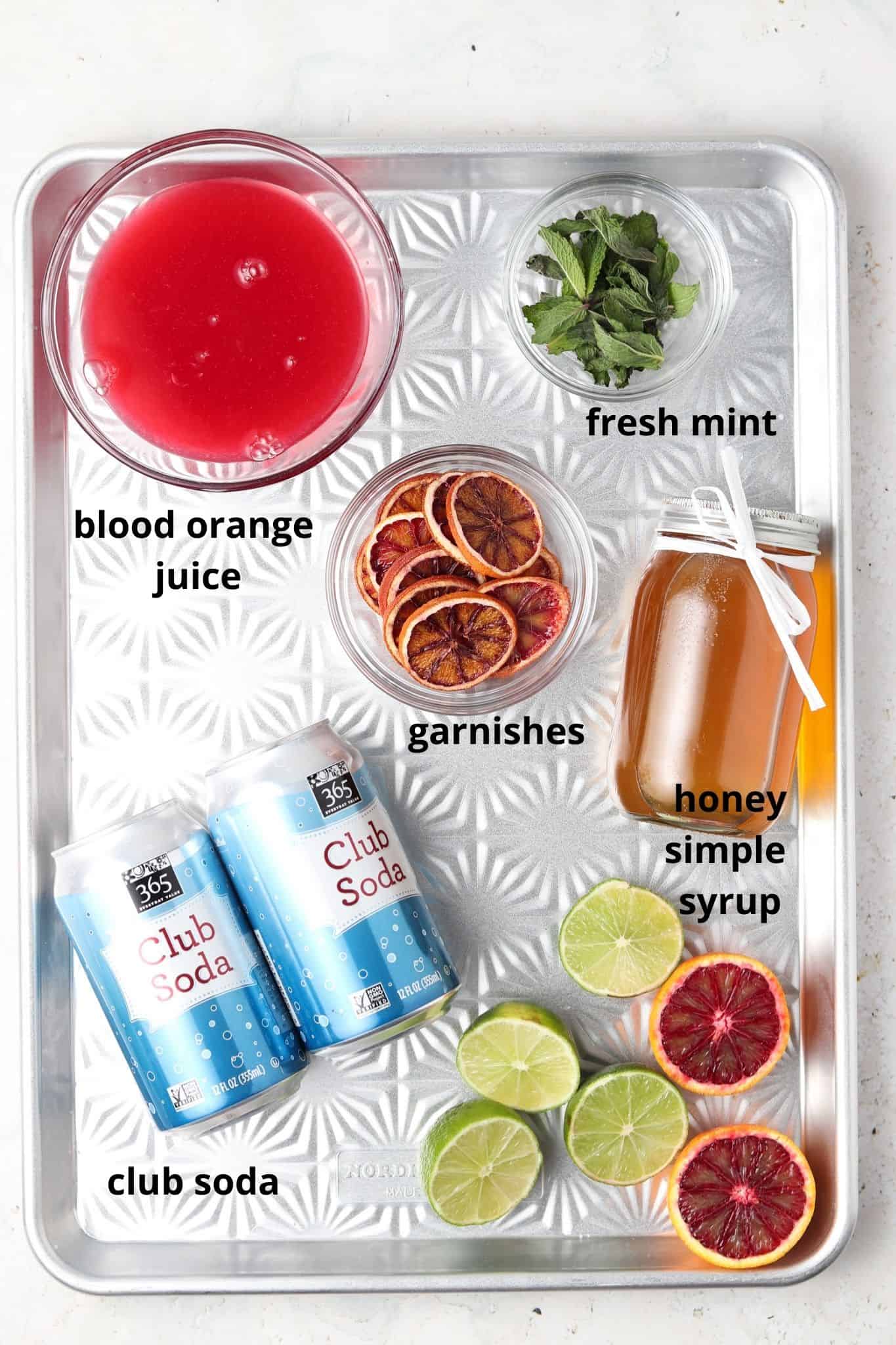 blood orange mojito mocktail ingredients on a metal tray