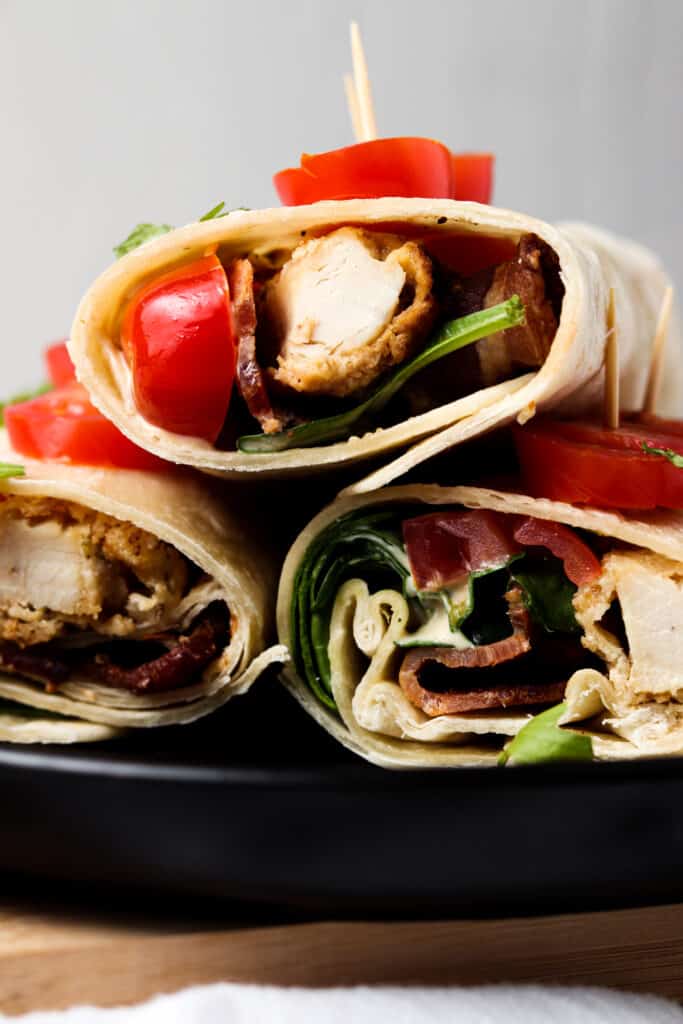 front shot of crispy ranch wraps on black plate