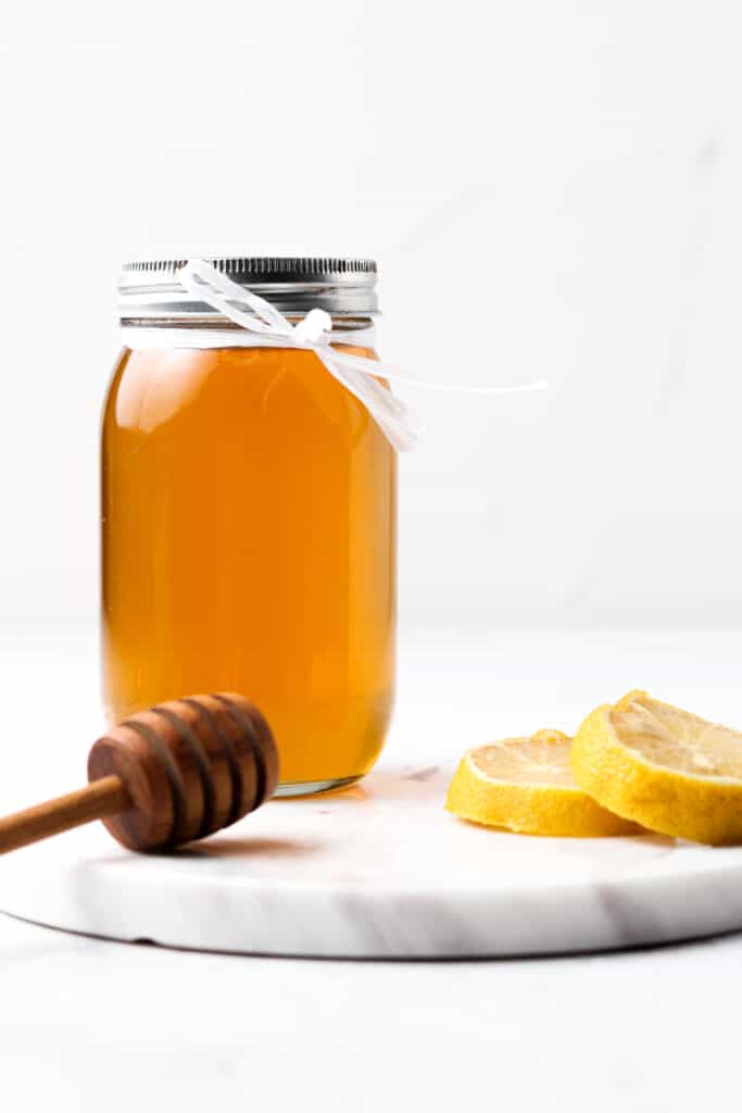 front photo of honey simple syrup in a mason jar