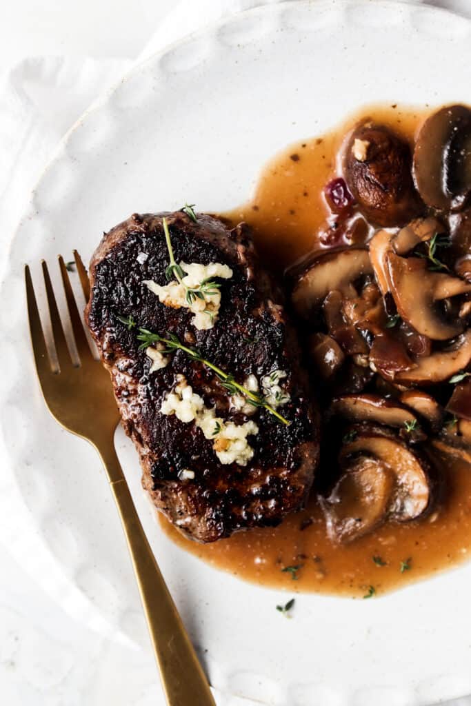 pan seared filet mignon on a plate with a fork