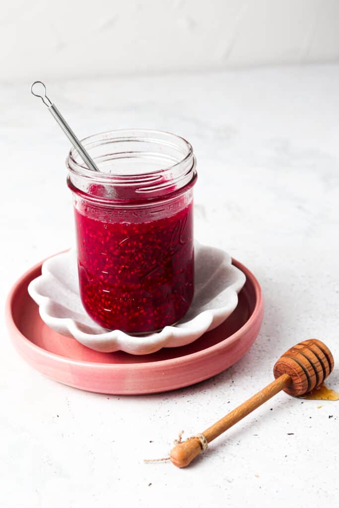 paleo raspberry jam on the counter in a mason jar