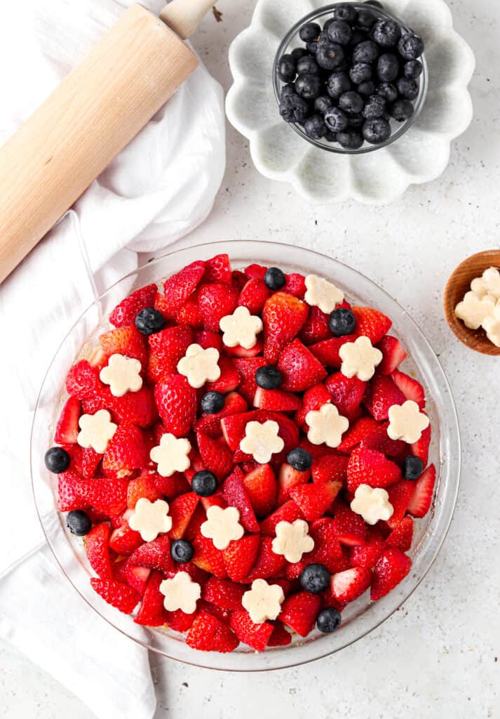 aip pie crust in a pie dish with a rolling pin