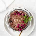 Beef liver pate in a white bowl with a spoon.