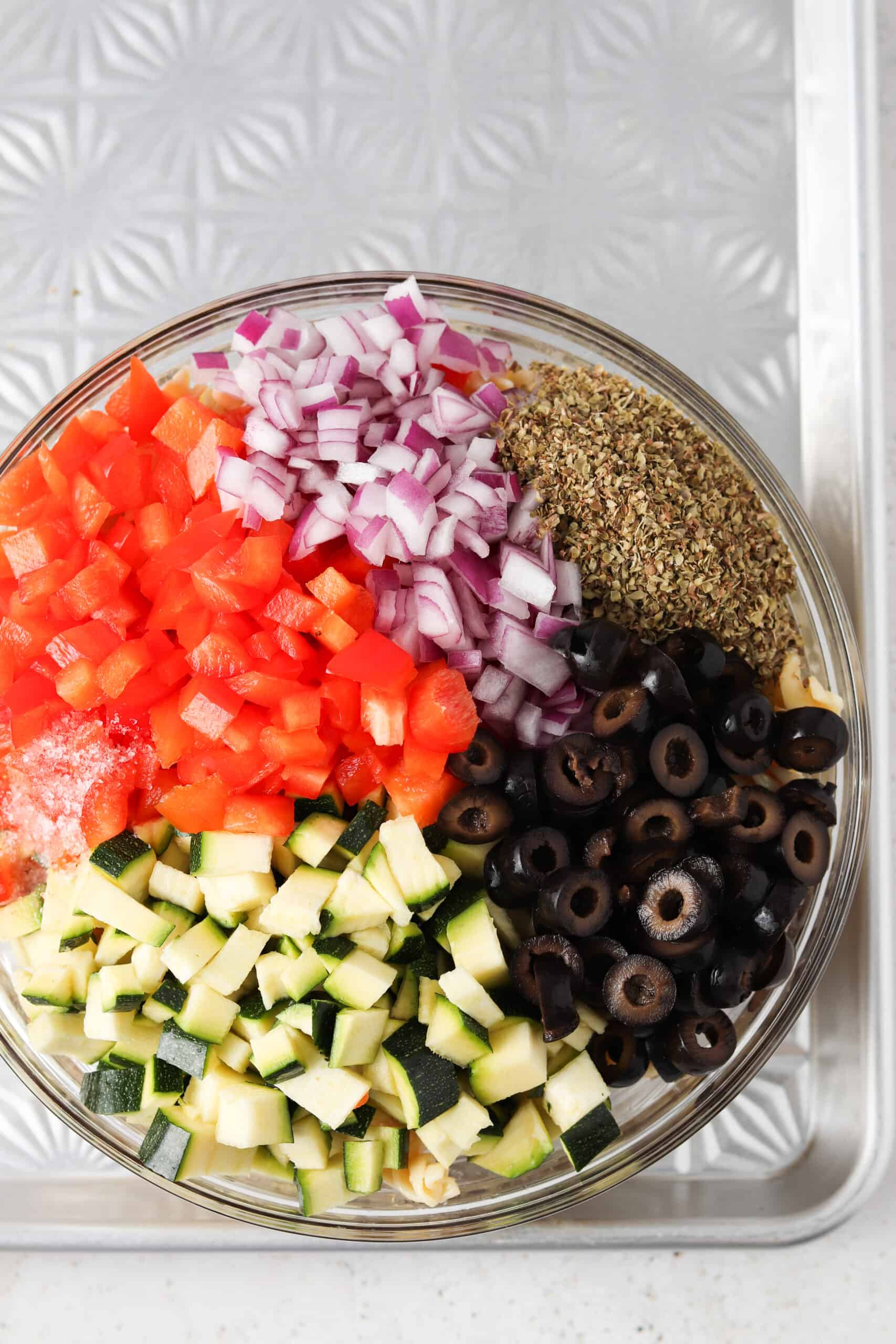 Paleo pasta salad ingredients in a large mixing bowl.