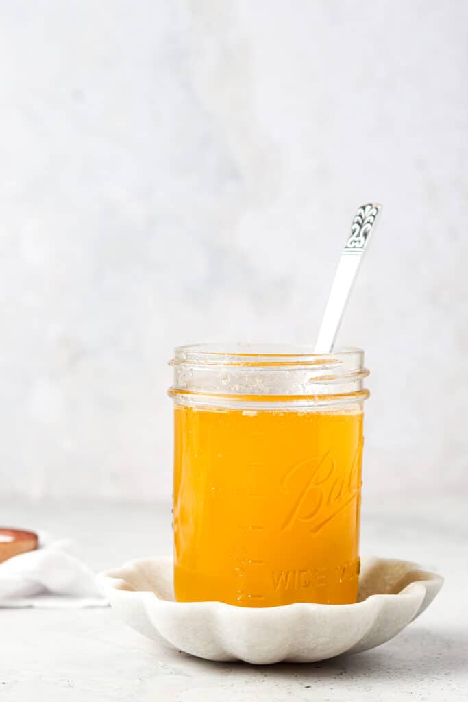 clarified butter in a mason jar in a spoon