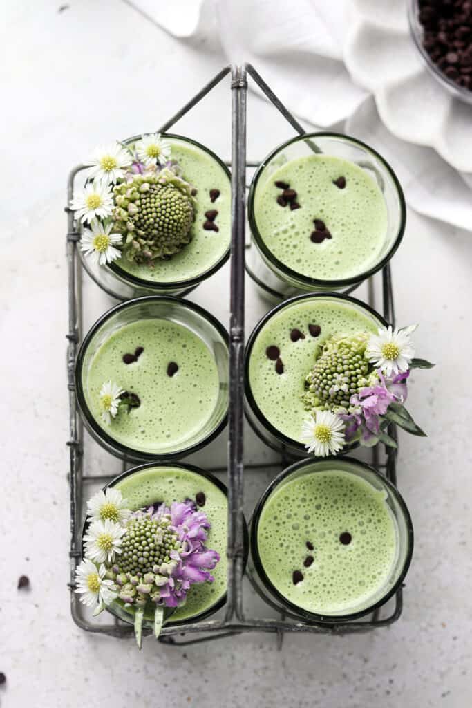 mint smoothie overhead shot with flowers in the smoothie