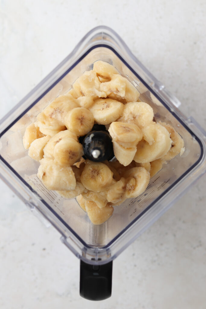 chopped up frozen bananas in a blender