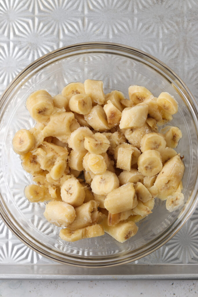 chopped up frozen bananas in a bowl