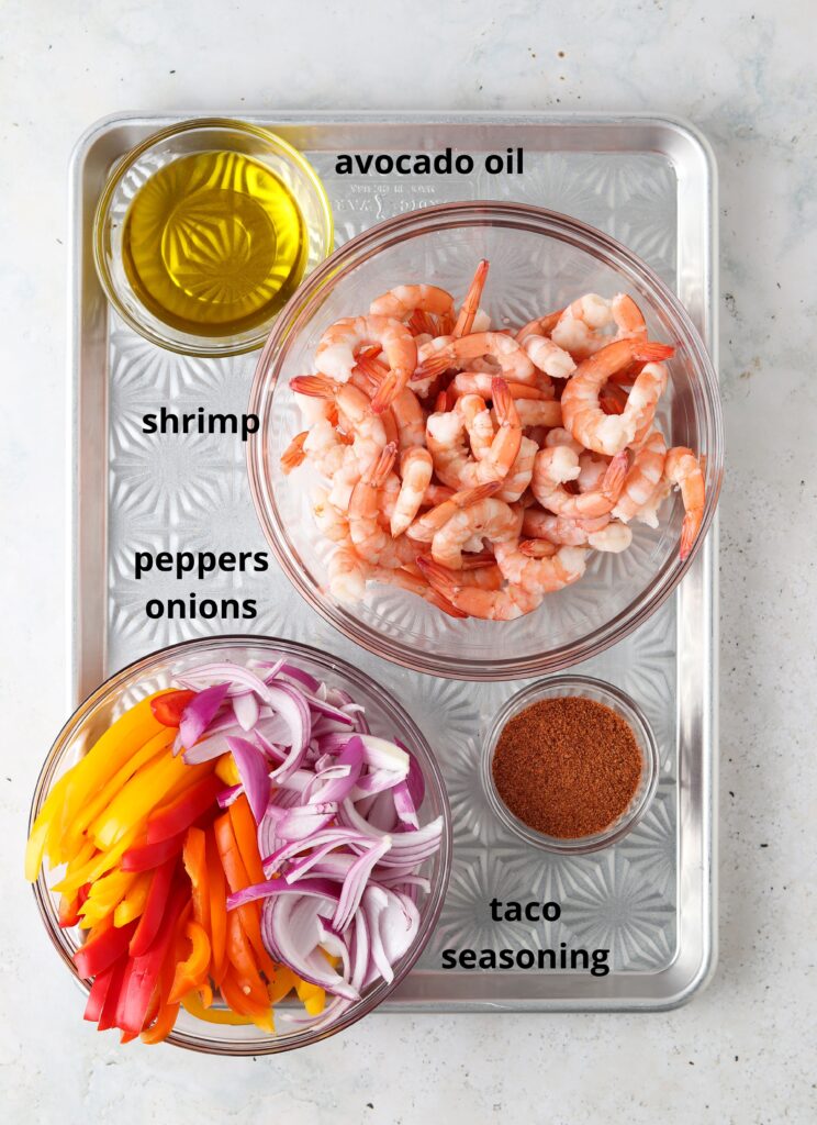 taco ingredients in bowls on a pan