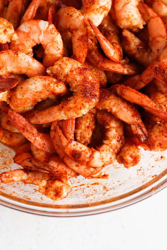 raw shrimp in a bowl with seasoning