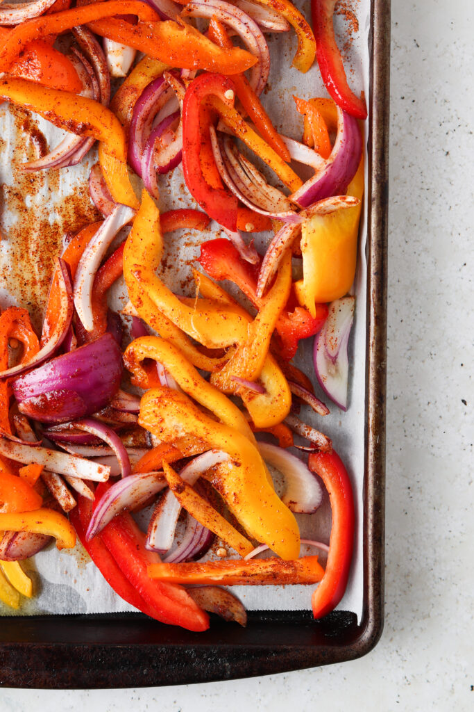 pepper and onions on a sheet pan