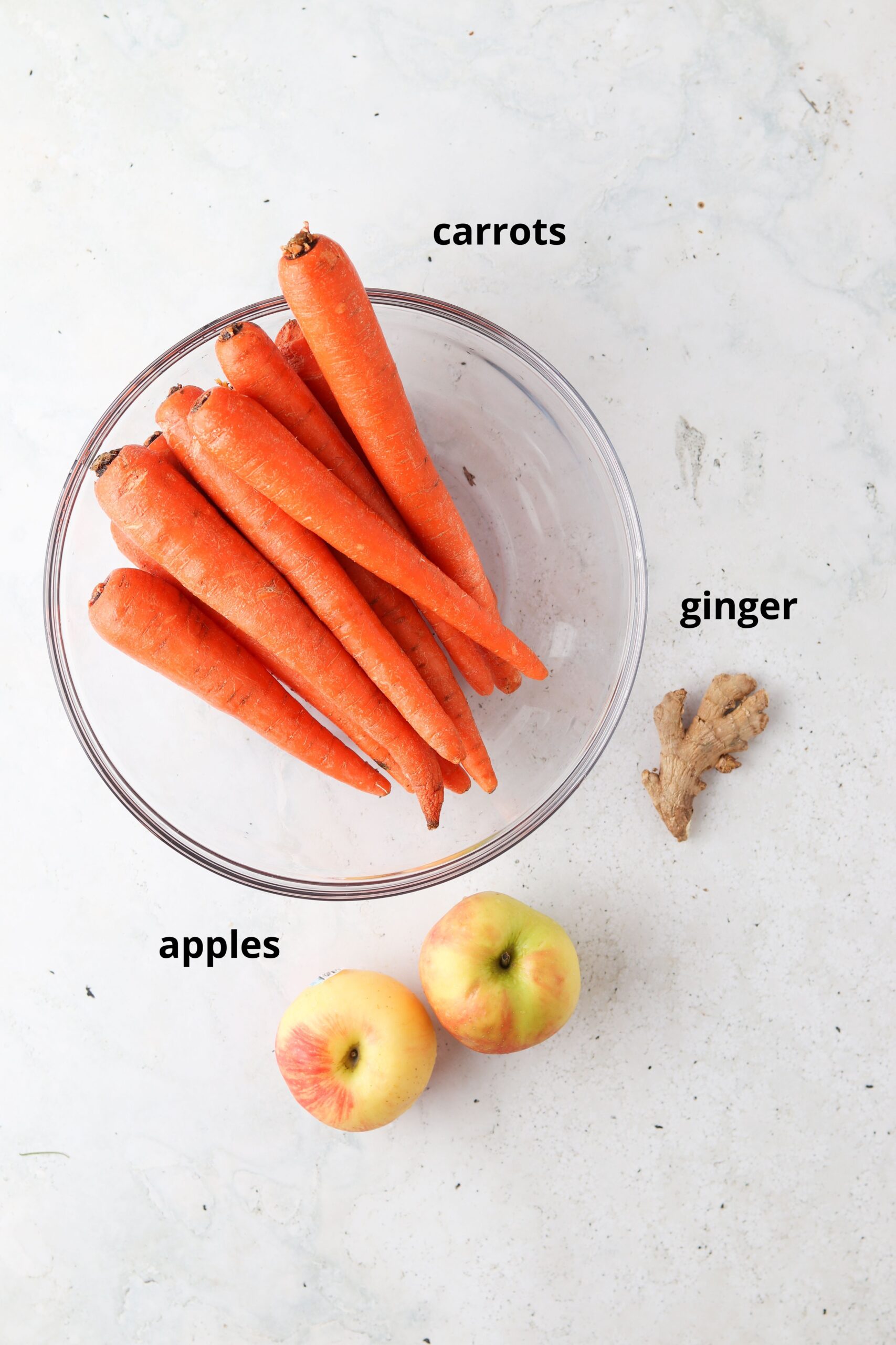 Carrot juice ingredients laid out on the counter top. 