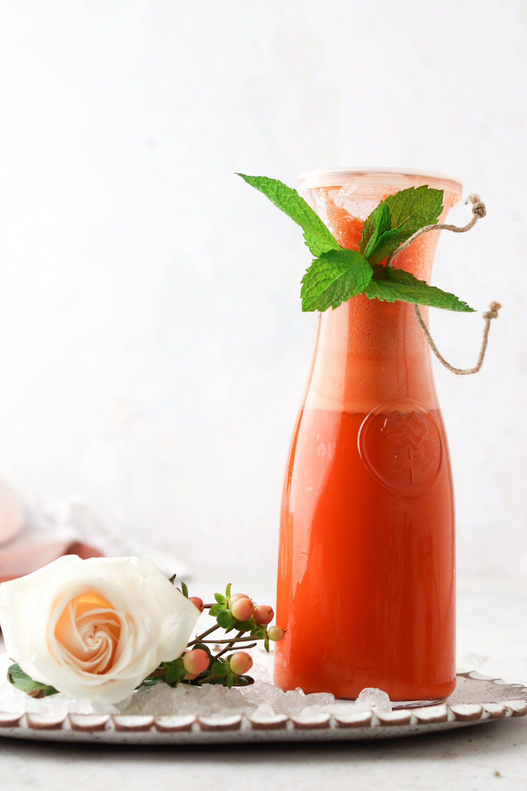 Fresh carrot juice stored in a juice container standing up.