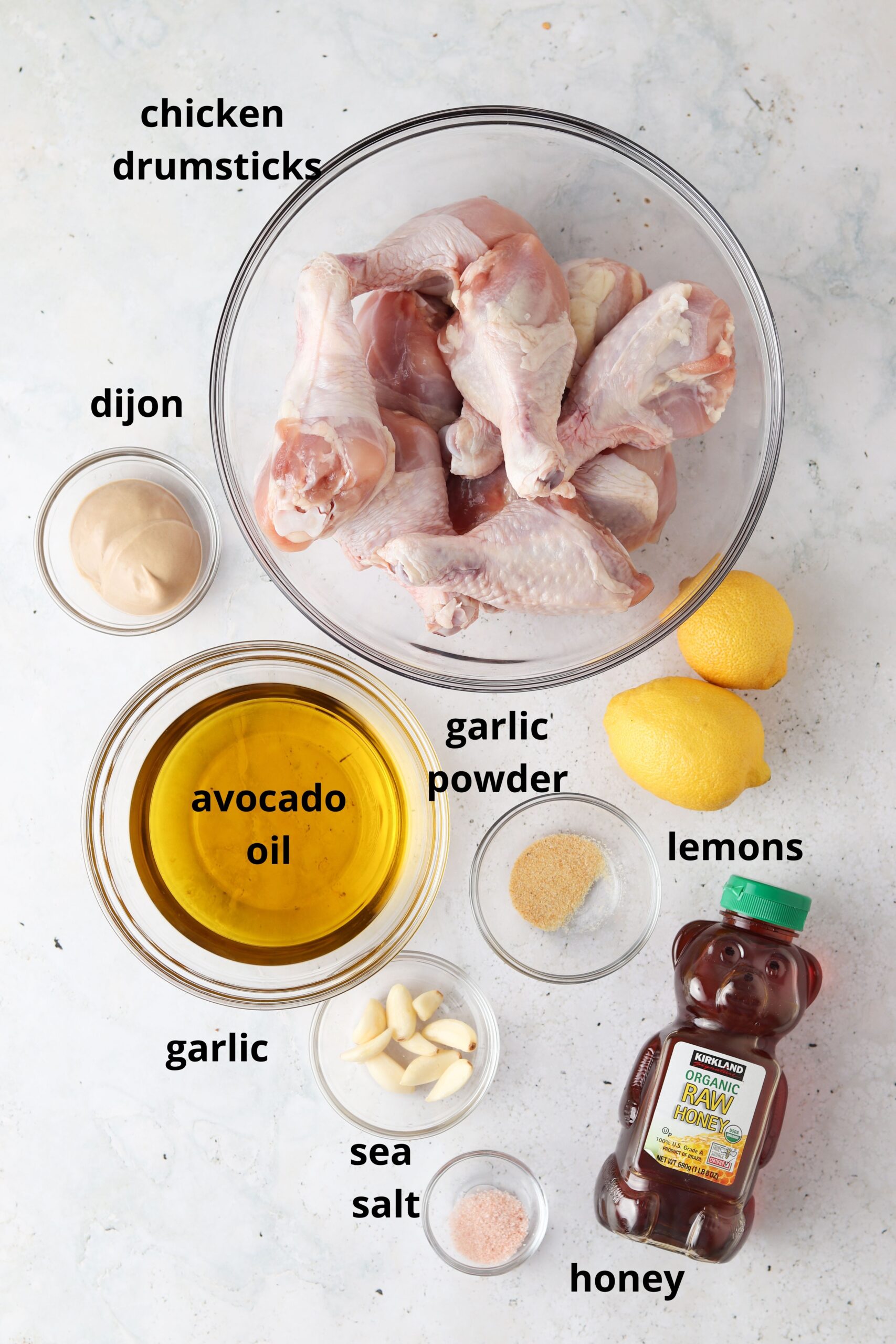 Ingredients for honey lemon garlic chicken in glass bowls. 