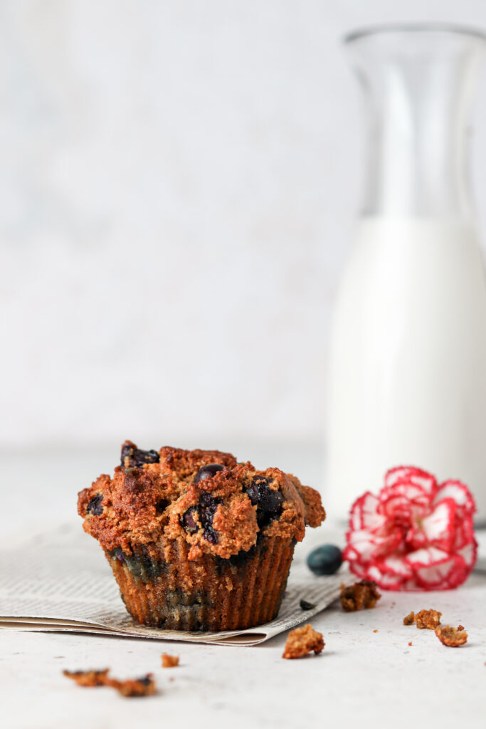 paleo blueberry muffin on a newspapper