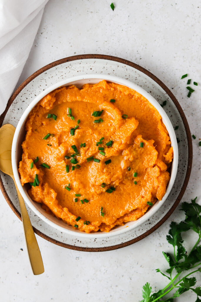 vegan sweet potato mash in a bowl with chives