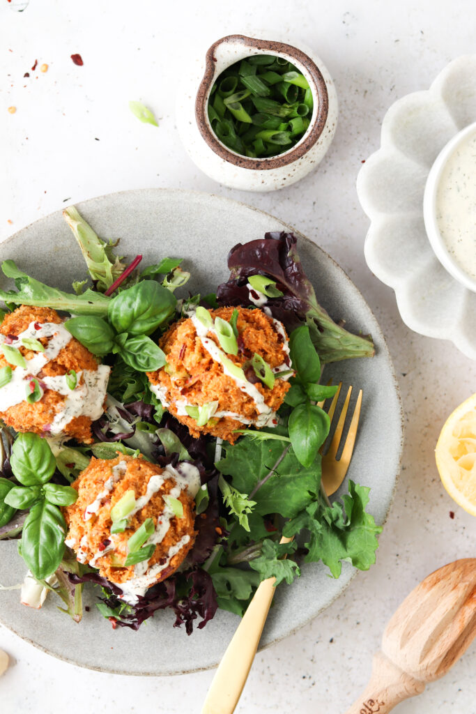 whole30 salmon cakes on a bed of greens