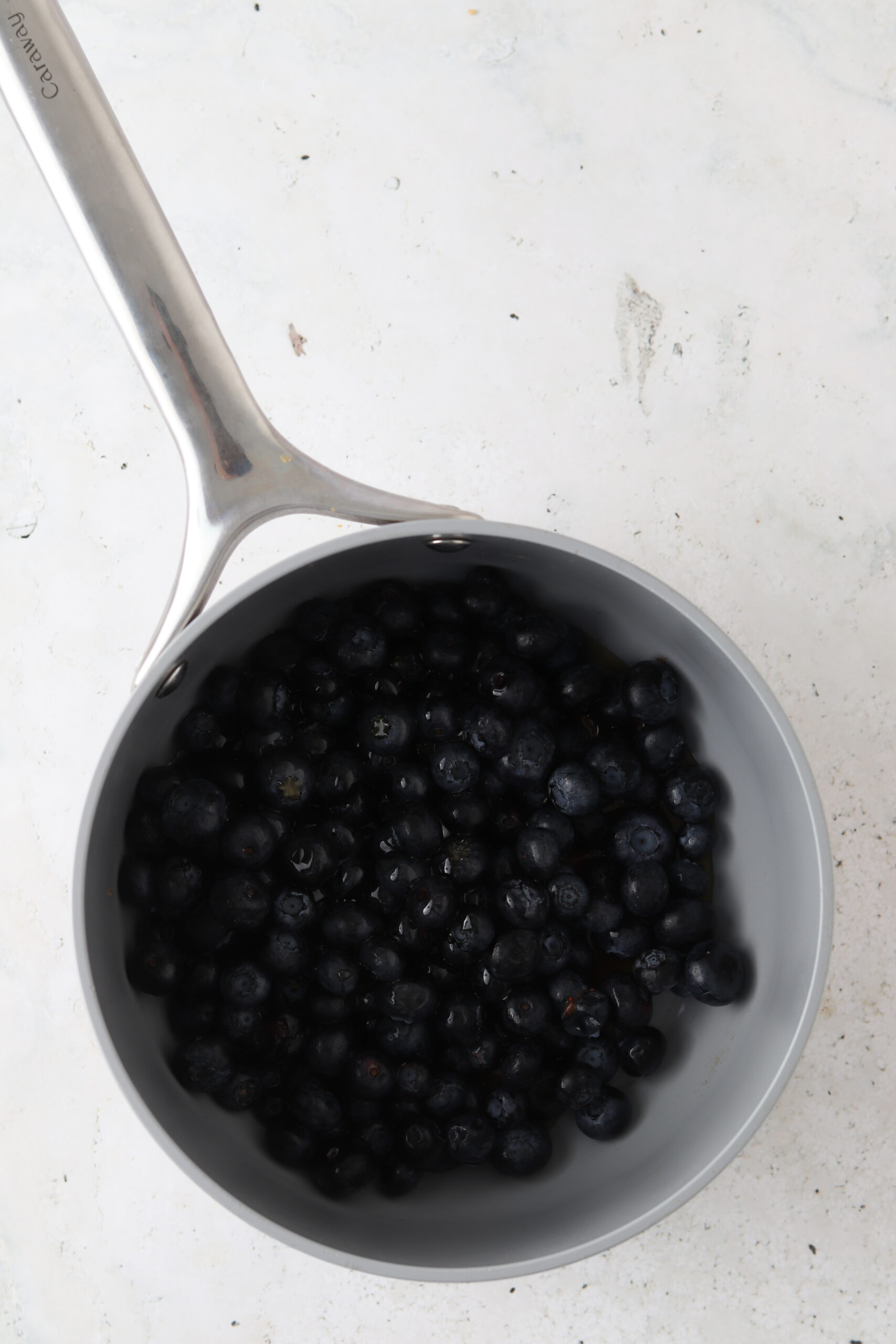 Blueberry maple jam ingredients in a saucepan.