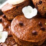 close up photo of zucchini muffins on a plate with chocolate chips