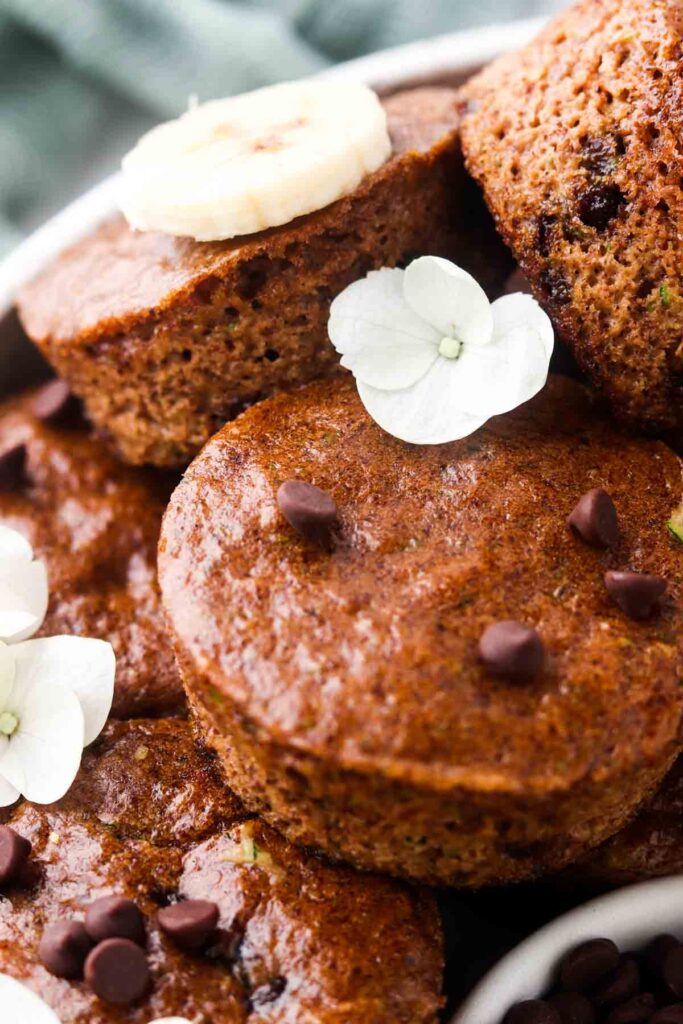 close up photo of zucchini muffins on a plate with chocolate chips