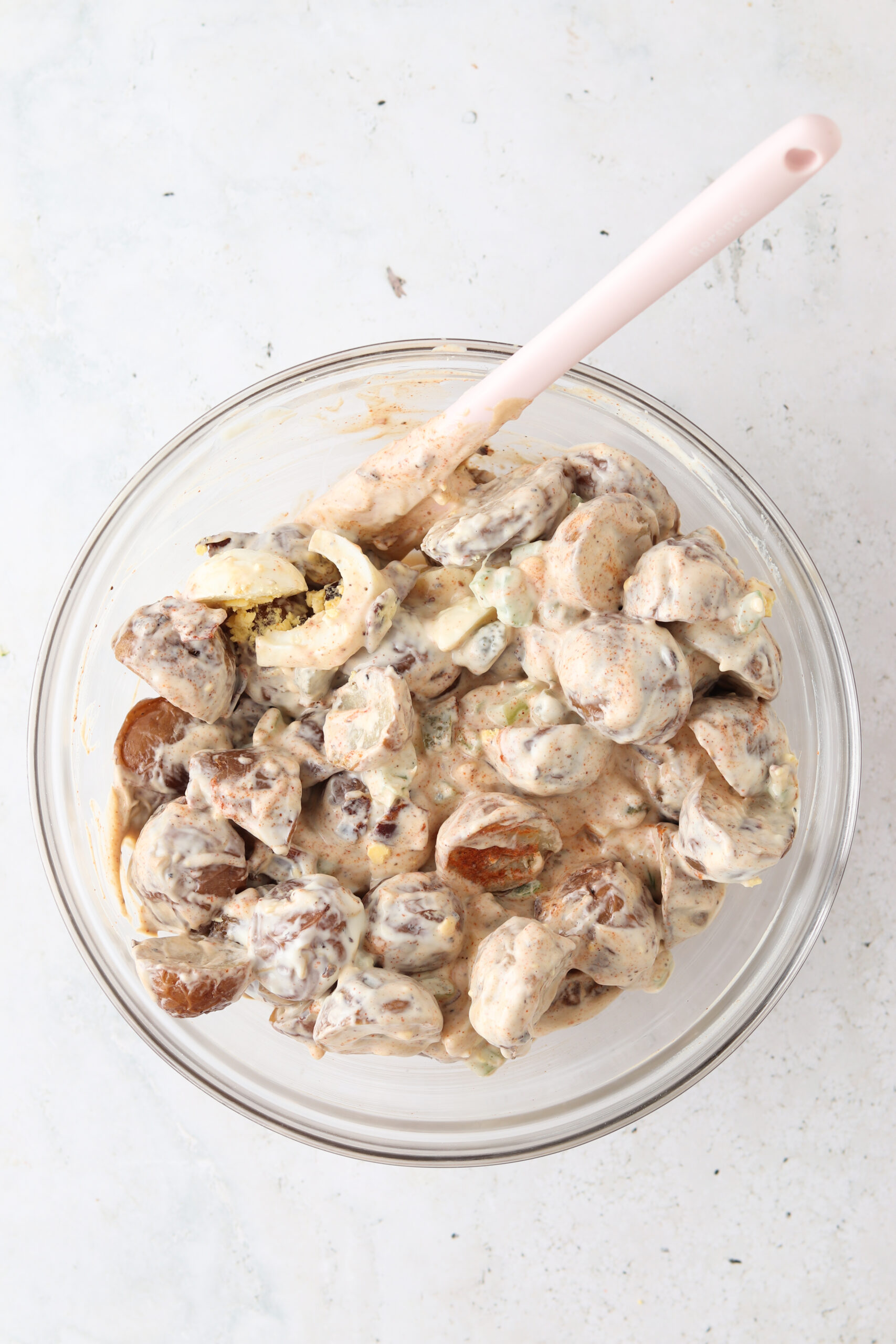 Mixed potato salad in a large glass bowl.