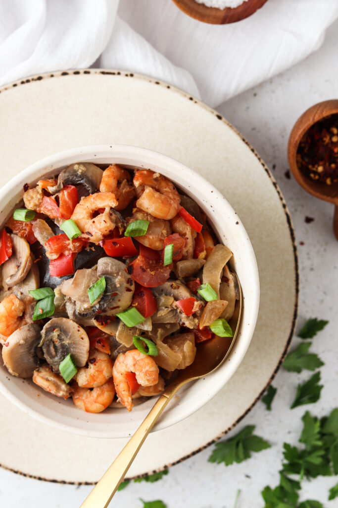 shrimp soup in a bowl with fresh herbs