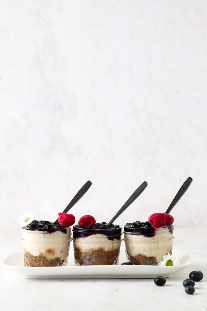 three vegan blueberry cheesecake cups