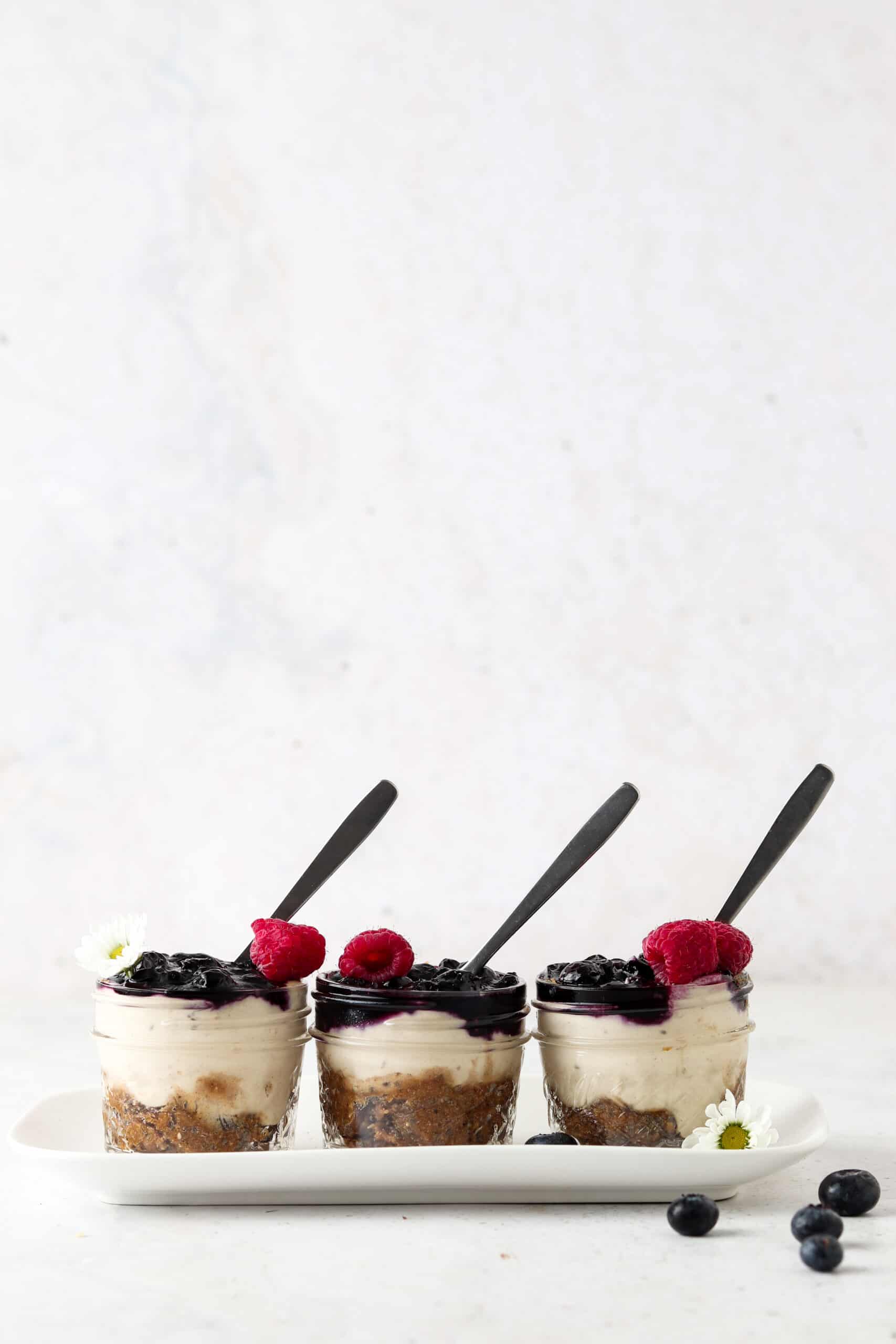 Vegan blueberry cheesecake jars on a tray. 