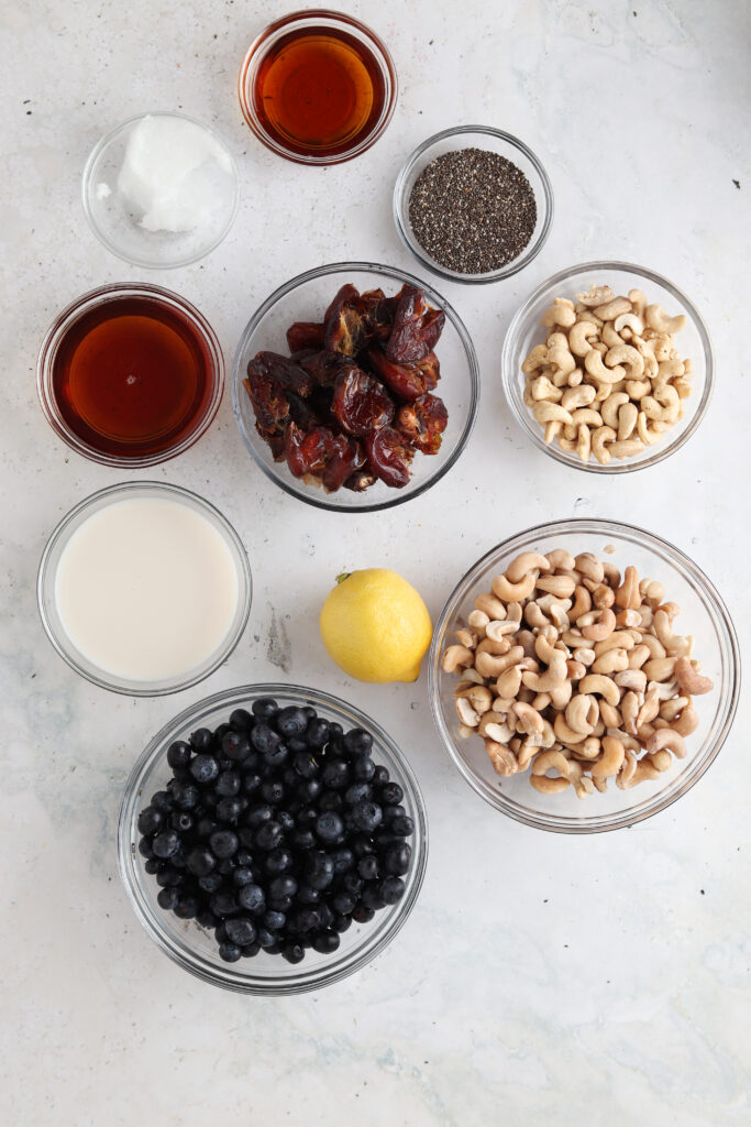 vegan blueberry cheesecake ingredients in small bowls
