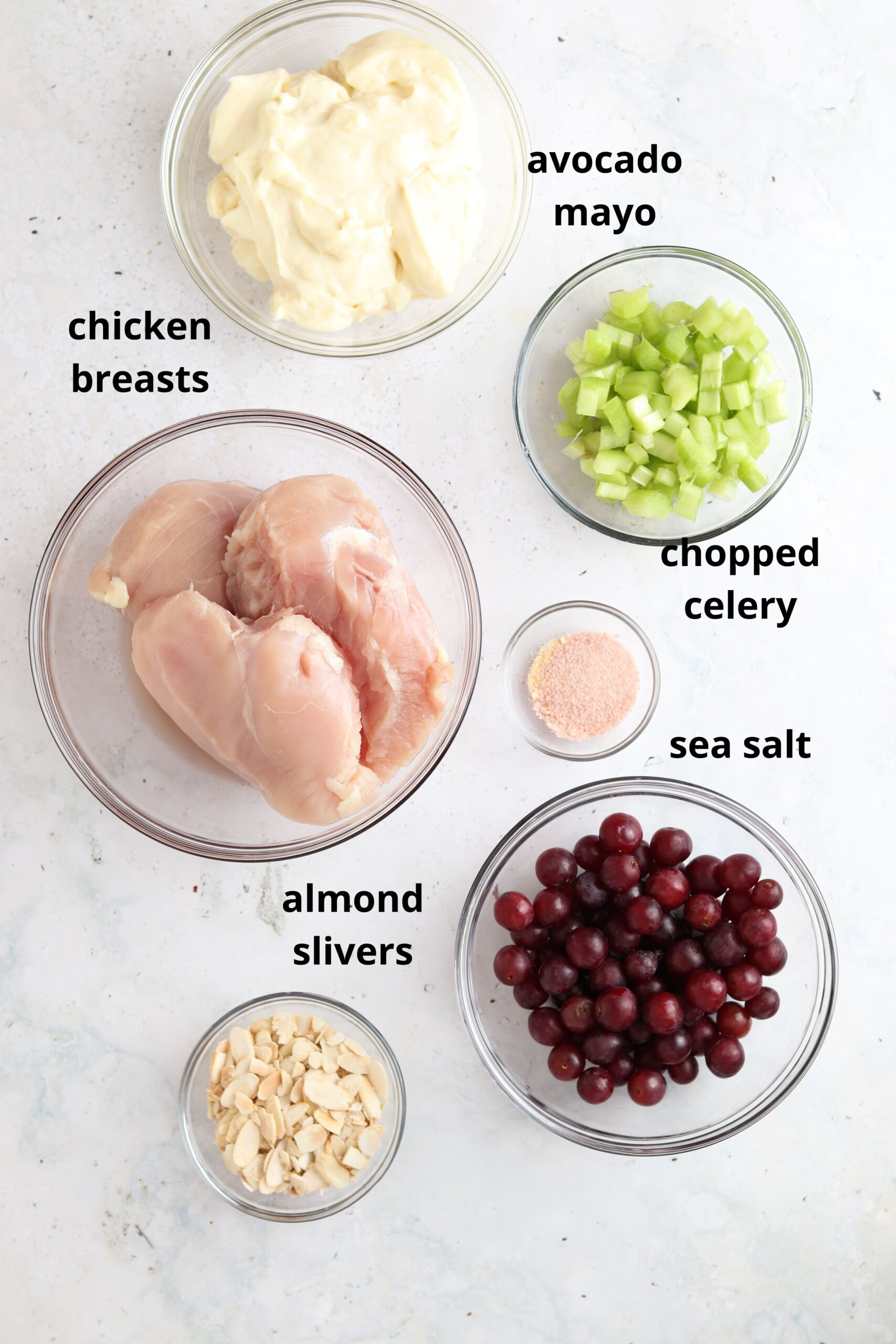 Whole30 chicken salad ingredients in small glass bowls. 