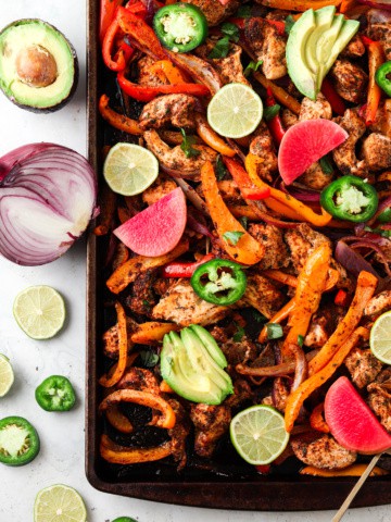Sheet Pan Chicken Fajitas with lime wedges and jalapeño no slices