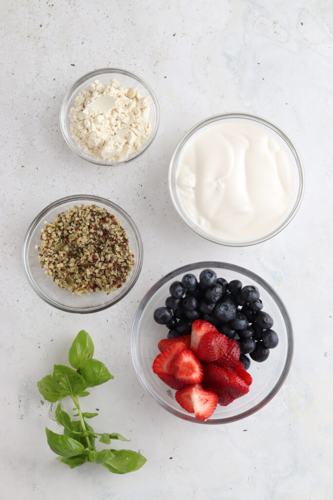blueberry and strawberry smoothie ingredients laid out in bowls