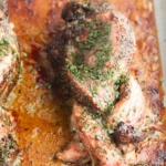 Braided pork on a baking sheet marinated with spices and oil.