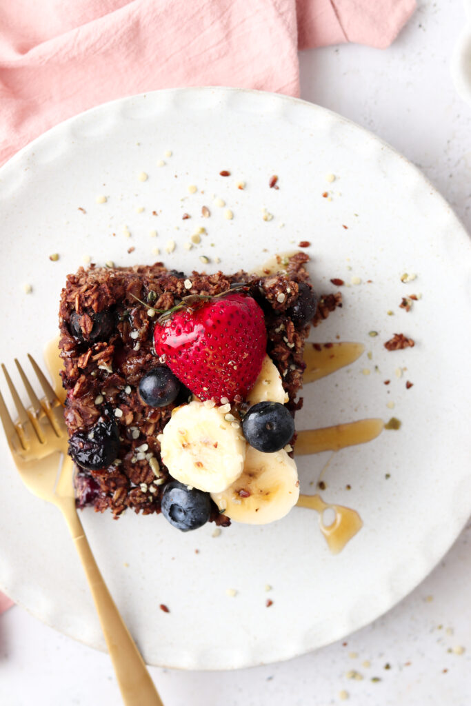 chocolate baked oats on a plate with berrries