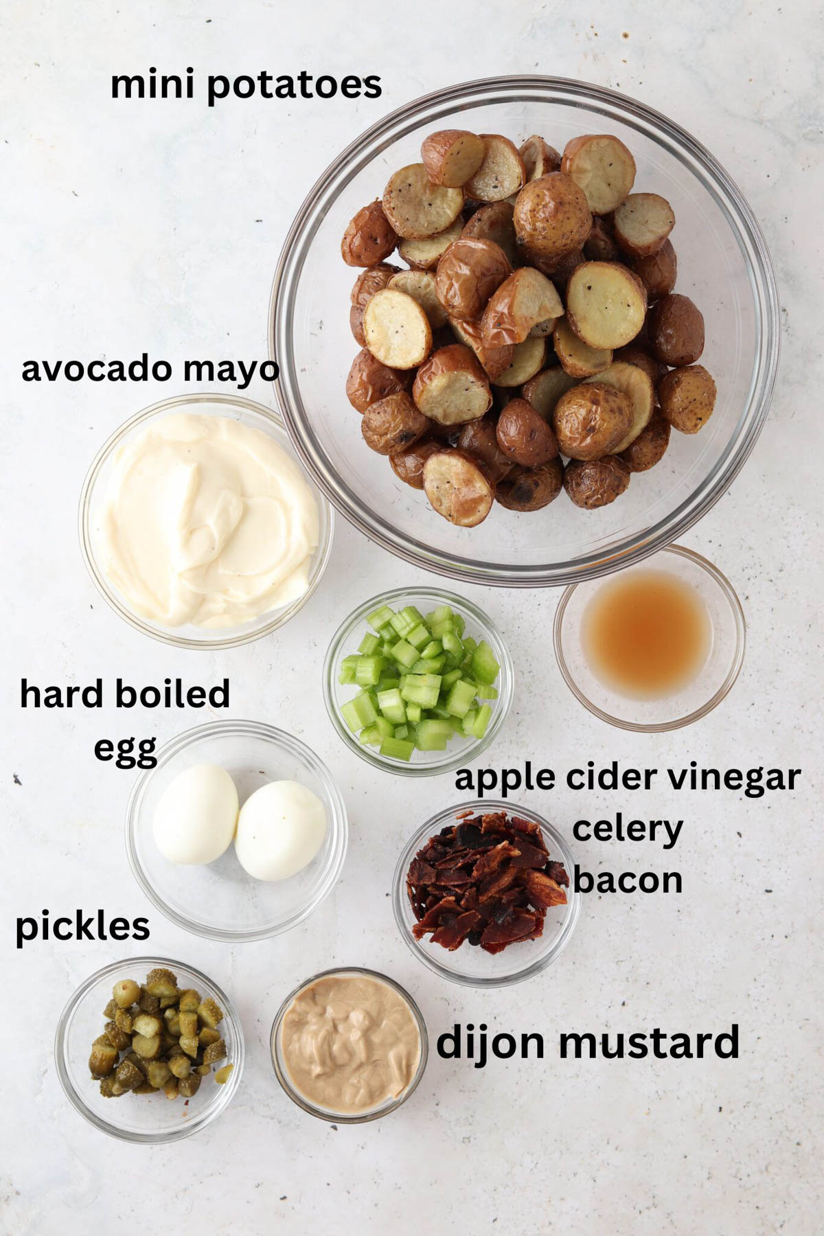 Whole30 potato salad ingredients in small glass bowls.