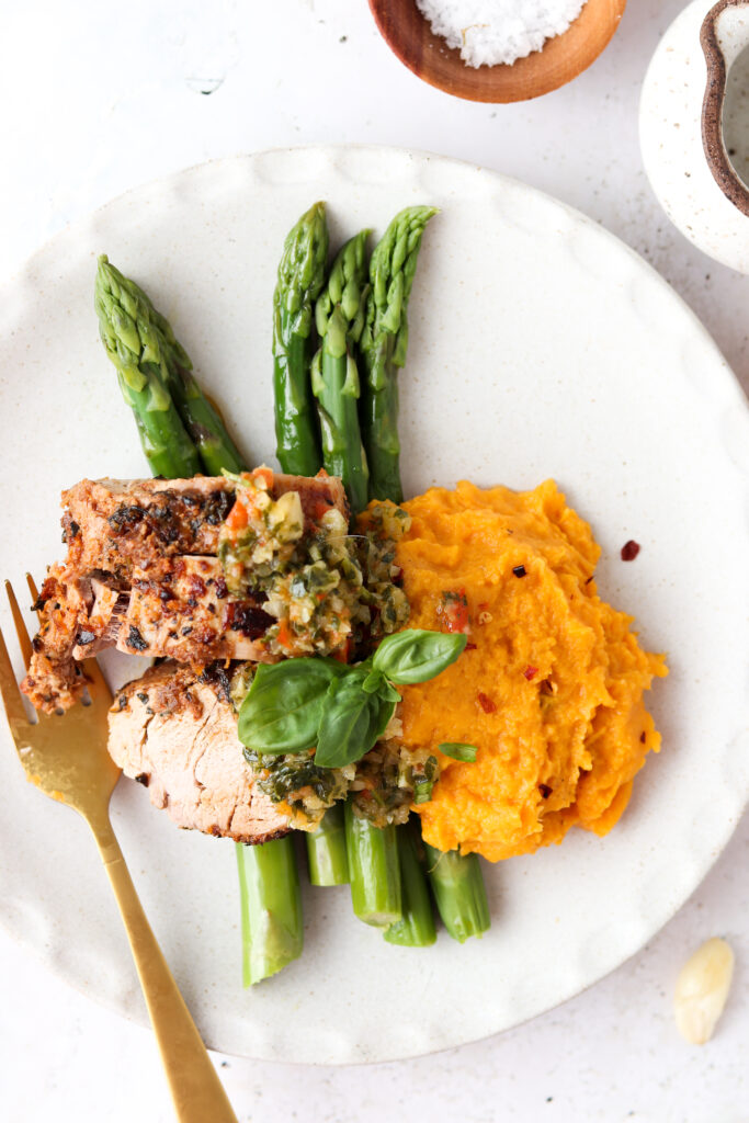 overhead shot of whole30 pork tenderloin with sweet potato mash and asparagus