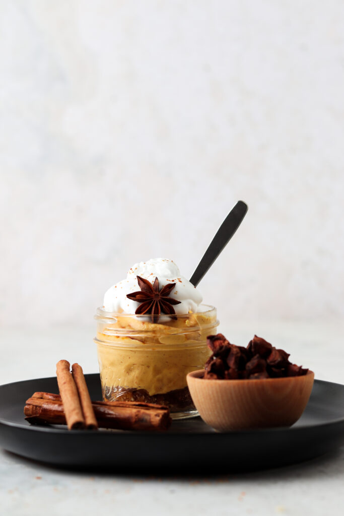 paleo pumpkin cheesecake in a jar with cinnamon