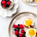 Prosciutto Egg Cups on a plate with fruit