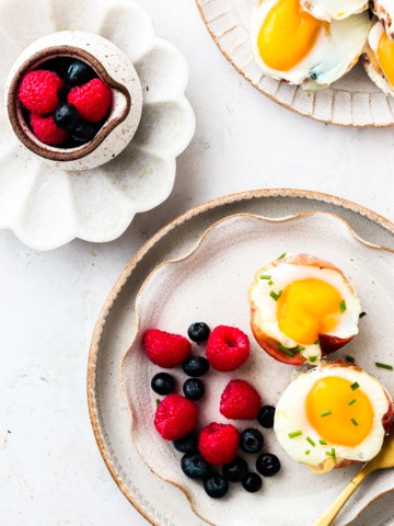 Prosciutto Egg Cups on a plate with fruit