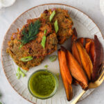 aip salmon cakes on a plate with fresh pesto sauce