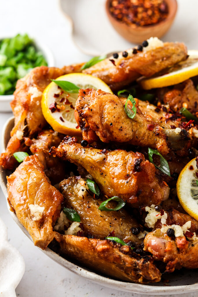 side shot of honey lemon pepper wings in a bowl