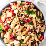 thai pasta salad in a blue bowl with a gold spoon