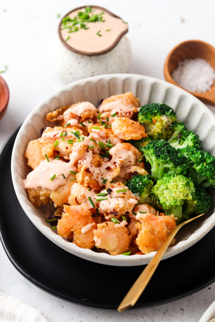 side shot of bang bang shrimp in a bowl