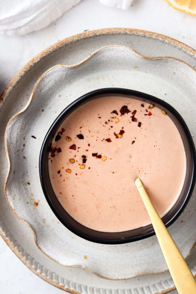 dairy free bang bang sauce in a black bowl