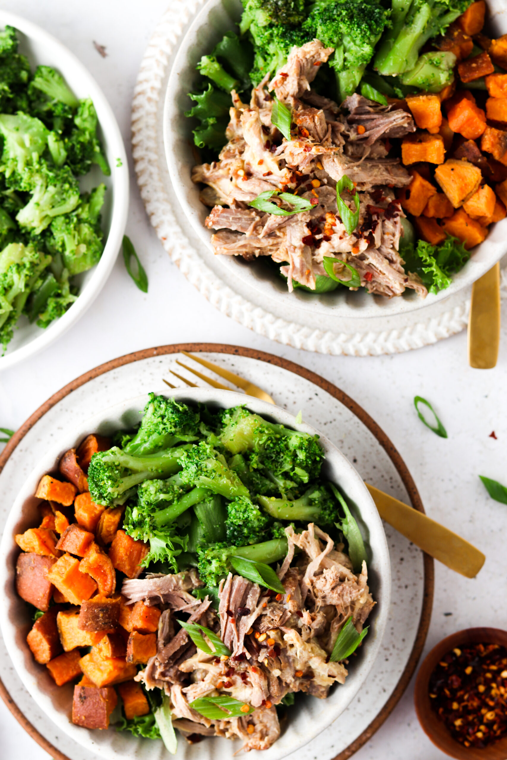 Honey mustard pork butt in a white bowl with broccoli and sweet potatoes.