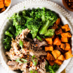 pork butt in a bowl with sweet potatoes and broccoli