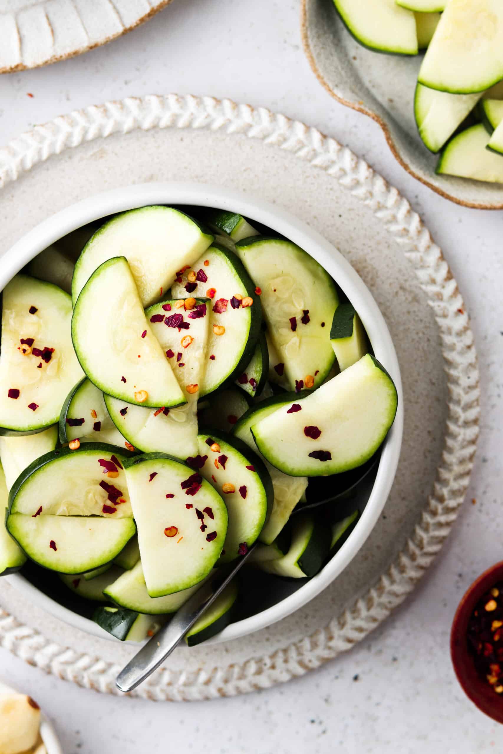 Instant pot zucchini in a bowl and garnished with red pepper flakes. 